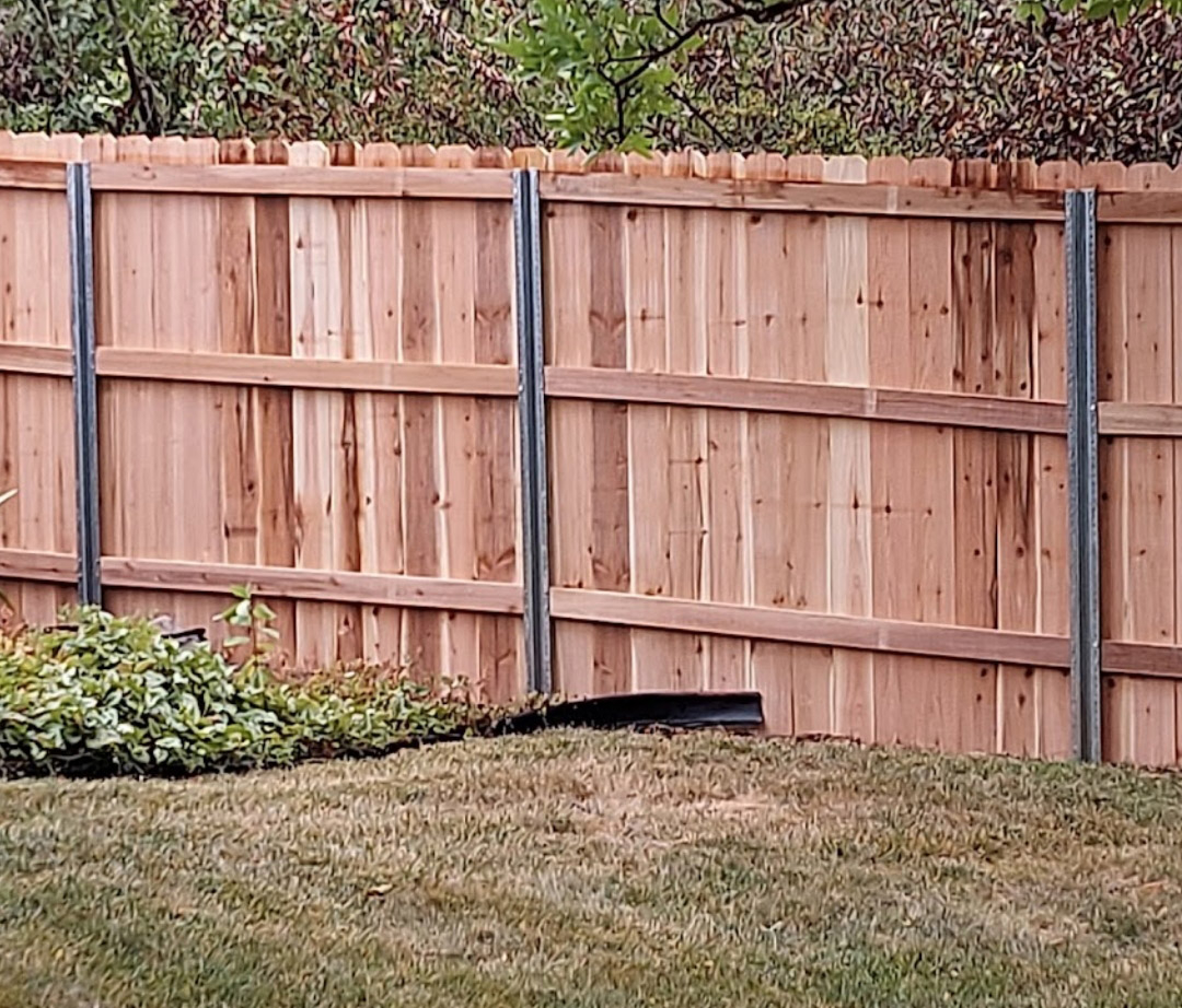 Metal Fence Post For Wood Fence throughout Why Metal Posts Are the Secret to a Wood Fence That Lasts Decades