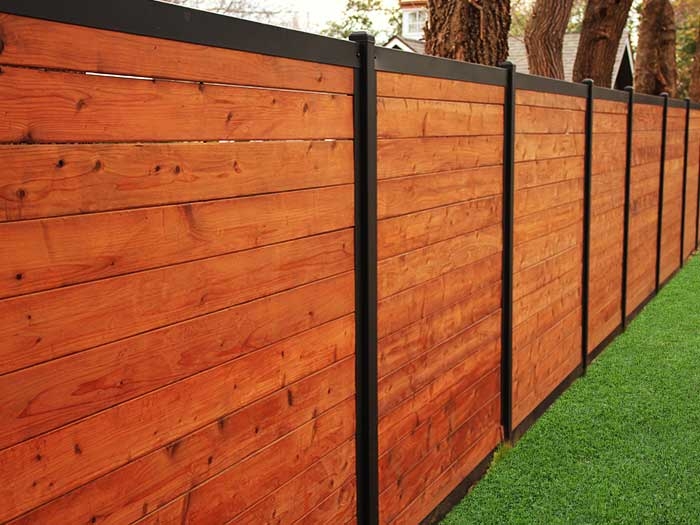 Build A Wood Fence With Metal Posts (That's Actually Beautiful) pertaining to Black Metal and Cedar Wood Create the Most Striking Fence Contrast